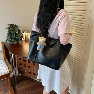 Black leather tote bag with cute bear pendant, casual large capacity shoulder bag for women.