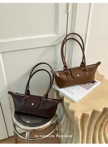 Detailed view of minimalist leather underarm shoulder bag, elegant casual everyday fashion style.