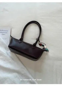 Minimalist dark brown underarm shoulder bag for women, trendy chic handbag with bead pendant.