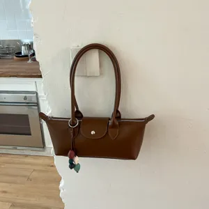 Classic brown leather underarm shoulder bag for women, stylish minimalist commuting handbag.