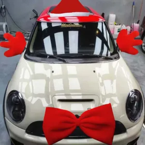 Christmas car decoration set including big red bow and plush gloves for holiday styling.