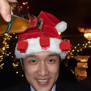 Festive red plush Christmas hat with shot glass holders for party fun and holiday celebration.