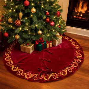 Detailed scene of red velvet Christmas tree skirt with golden embroidery and sequin decorations.