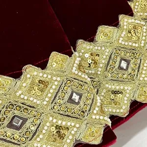 Red velvet Christmas tree skirt trim featuring gold embroidery, sequins, and pearls.