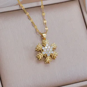 Gold snowflake pendant necklace detail view, sparkling rhinestone clavicle chain jewelry.