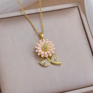 Chic gold-tone rotating pink sunflower pendant necklace with sparkling stone leaf details.