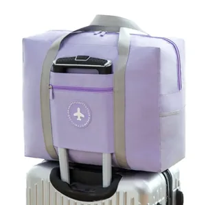 Large purple travel duffel bag featuring convenient luggage trolley sleeve for outdoor trips.