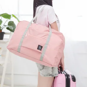 Pink foldable travel duffel bag detail view, large capacity waterproof luggage storage bag.