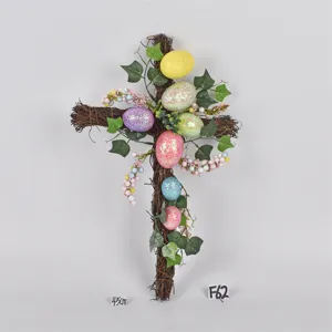 Easter twig cross hanging decoration with colorful glitter eggs and ivy leaves for spring decor.