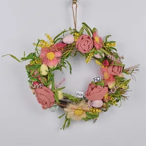 Easter wreath detail, handmade burlap rose and colorful egg hanging decoration for spring decor.