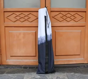 Portable freediving fin bag with black and white gradient design, adjustable strap.