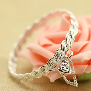 Primo piano di un bracciale rigido vintage in argento con ciondolo Buddha