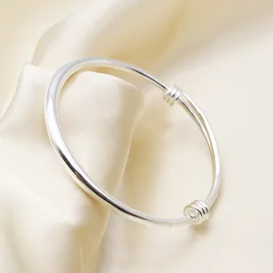 Primo piano di un bracciale regolabile in stile etnico argentato su seta elegante