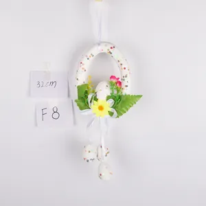 Easter hanging decoration egg wreath with colorful sequins flowers and ribbon for party decor.