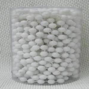 White plastic bead chain in a clear container for Christmas tree decoration and holiday crafts.