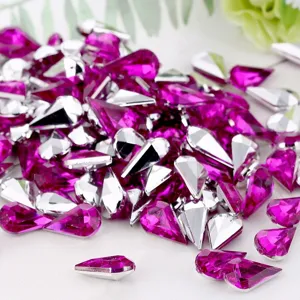 Drop-shaped acrylic point-back rhinestones detail view, vibrant pink sparkle gems.