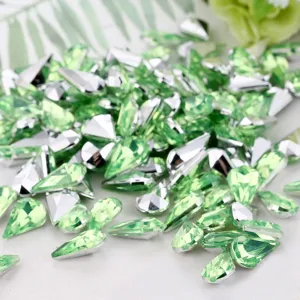 Drop-shaped green acrylic rhinestones with silver backing for DIY crafts and jewelry making.