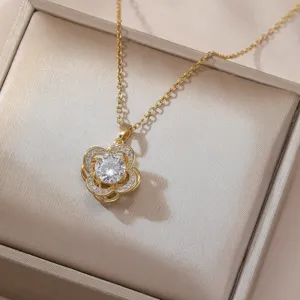 Exquisite detail view of the gold rotating four-leaf flower zircon necklace in a gift box.