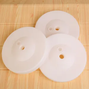 Detail view of white round plastic water-fillable balloon base for party decoration setup.