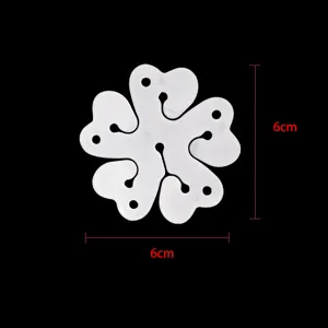 Detail view of the 6-in-1 white plastic plum blossom balloon clip, showing size and slot design.