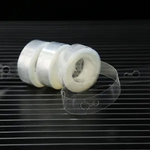 Close-up detail of clear plastic balloon chain strip for party arch decoration and balloon fixing.