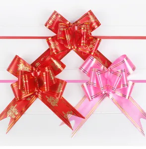 Wedding decorative pull bows, large gold-edged red and pink ribbon bows for car and event decor.