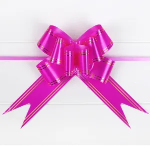 Large pink pull bow with gold stripes for wedding car decoration, gift wrapping, and party supplies.