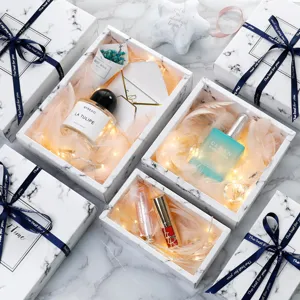 Luxury marble gift box set with perfume, cosmetics, feathers and fairy lights for special occasions