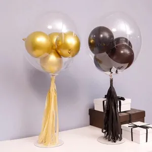 Transparent bobo balloon with small balloons inside, tassel decor, and base for party setup.