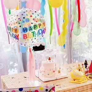 Detailed view of table balloon stand kit with clear confetti balloon for birthday party decor.