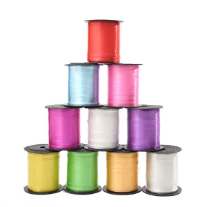 Kleurrijke ballonlinten op plastic spoelen voor geschenkverpakking en feestelijke decoratie.