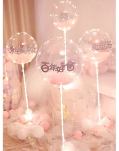 Detail shot of glowing bobo balloons with fairy lights for wedding party celebration setup.