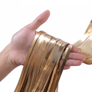 Gold foil fringe curtain detail view showing matte metallic texture for party and wedding backgrounds.