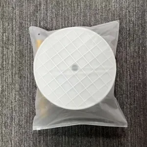 Close-up detail of white round grid base component for balloon arch kit in transparent bag.