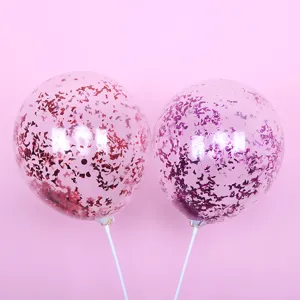 Close-up detail shot of clear transparent confetti balloons filled with shiny pink glitter flakes.