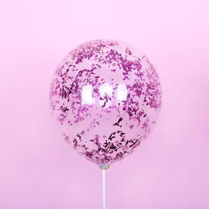 Transparent confetti balloon with magenta sequins and white stick for colorful party decoration.