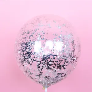 Transparent bubble balloon with silver confetti filling inside, detail view for party decor.
