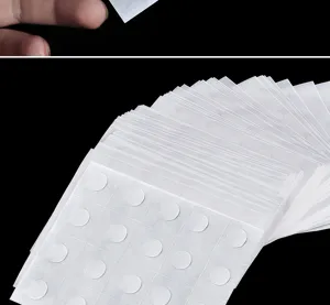 Detail view of transparent double-sided adhesive glue dots for balloons and crafts holding firmly.