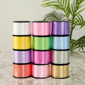 Colorful plastic balloon ribbons stacked together, ideal for gift wrapping and party decor.