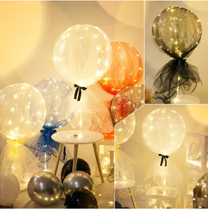 LED bobo balloon table centerpiece decor with tulle mesh and warm lights for party celebration.
