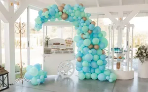 DIY balloon arch kit detail showing blue mint balloons and white dessert cart party decor setup.