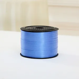 Close-up detail shot of blue plastic balloon ribbon roll for gift wrapping and decoration.