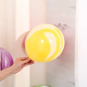 Close-up of a 10-inch yellow agate balloon showing its unique cloud marble pattern detail.
