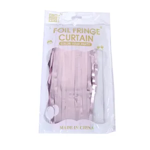 Detailed view of pink foil fringe curtain packaging, showing shiny metallic strands for parties.