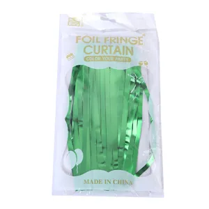Green foil fringe curtain detail, perfect for birthday party and wedding background decor.