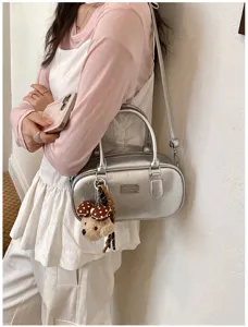 Silver bowling bag detail, glossy finish handbag with cute bear pendant and metal plaque.