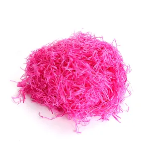 Vibrant pink shredded paper filler for gift boxes, ideal for secure packing and display.
