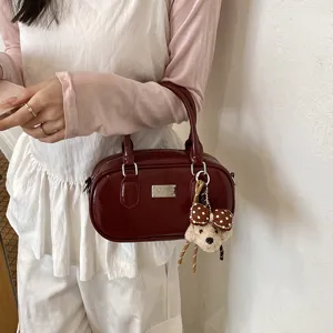 Vintage solid color bowling shoulder handbag with cute bear pendant for women summer daily use.