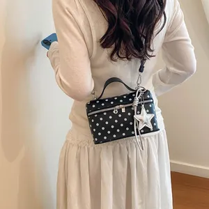 Classic black and white polka dot crossbody bag with chic star pendant for daily use.