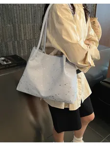 Canvas star rhinestone tote bag detail shot, blue casual commuter shoulder bag style.